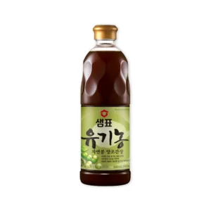 Sempio's Organic Natural Bean Brewed Soy Sauce product bottle, shown with organic soybeans to highlight its main ingredient.